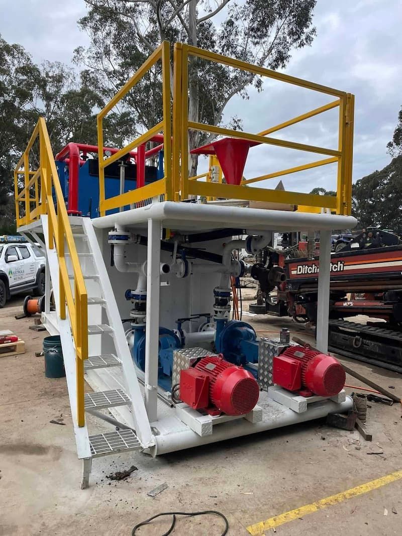 A Machine with Stairs and A Yellow Railing Is Sitting in A Parking Lot — Bay Coast Electrical & Control Solutions in Maloneys Beach, NSW