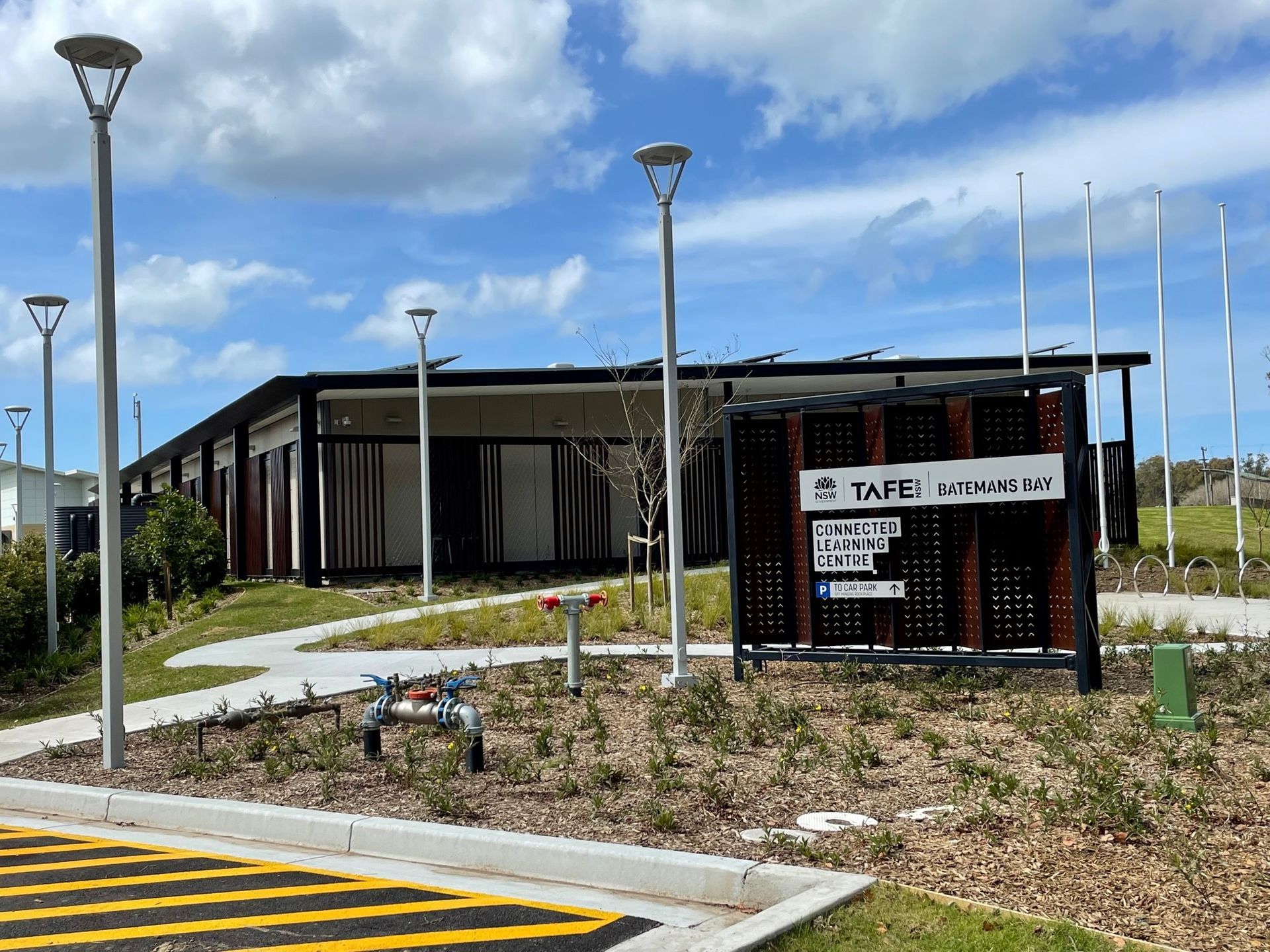 A Blue House With A Green Roof And Lots Of Windows — BayCoast Electrical & Control Solutions in Narooma, NSW