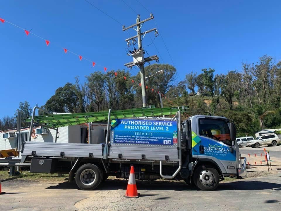 A Truck Is Parked In A Parking Lot Next To A Power Pole — BayCoast Electrical & Control Solutions in Ulladulla, NSW