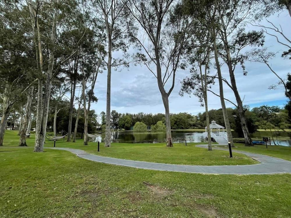 A Park with Trees and A Path Going Through It — Bay Coast Electrical & Control Solutions in Maloneys Beach, NSW