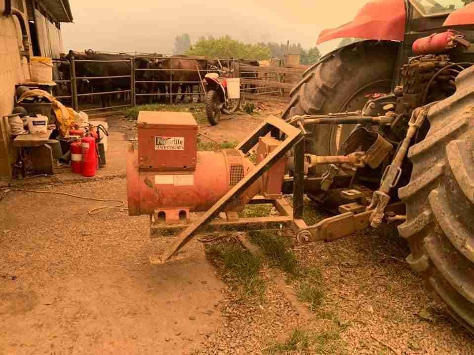 A Tractor Is Parked in A Dirt Lot Next to A Generator — Bay Coast Electrical & Control Solutions in Maloneys Beach, NSW