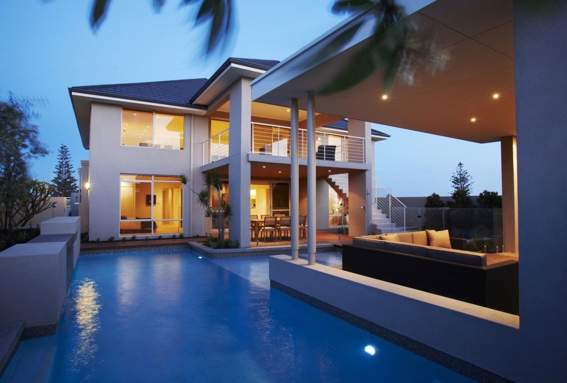 A Large House With A Swimming Pool In Front Of It — BayCoast Electrical & Control Solutions In Broulee, NSW