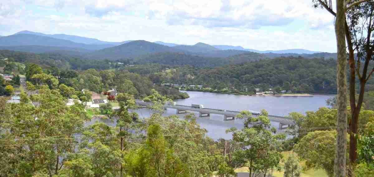 A View of A Lake Surrounded by Trees and Mountains — Bay Coast Electrical & Control Solutions in Maloneys Beach, NSW