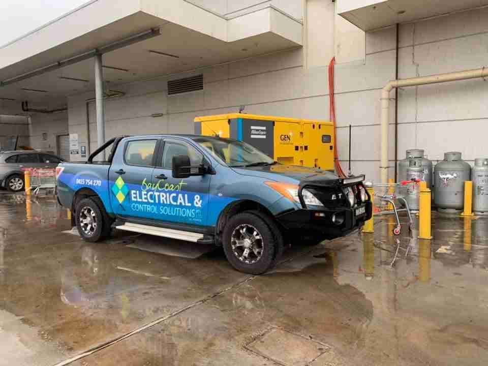 A Truck Is Parked in A Parking Lot in Front of A Building — Bay Coast Electrical & Control Solutions in Maloneys Beach, NSW