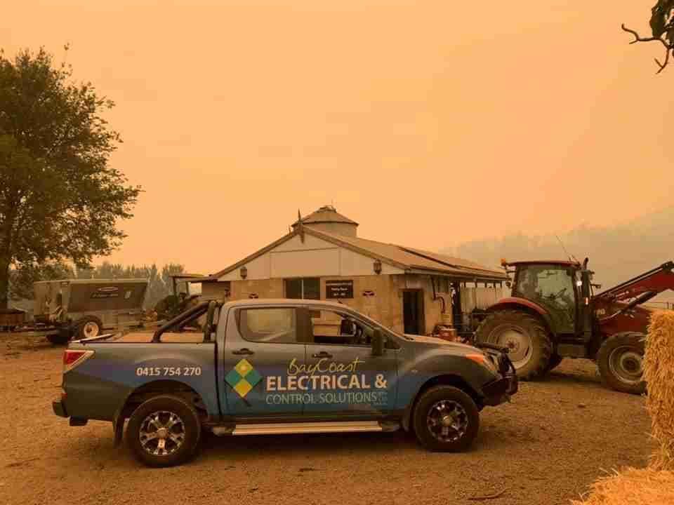 A Truck Is Parked in Front of A House with A Tractor in The Background — Bay Coast Electrical & Control Solutions in Maloneys Beach, NSW