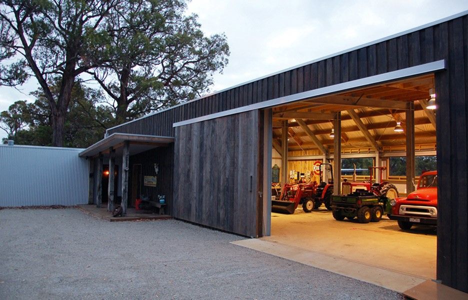 A Tractor Is Parked In A Garage With The Doors Open — BayCoast Electrical & Control Solutions In Nelligen, NSW