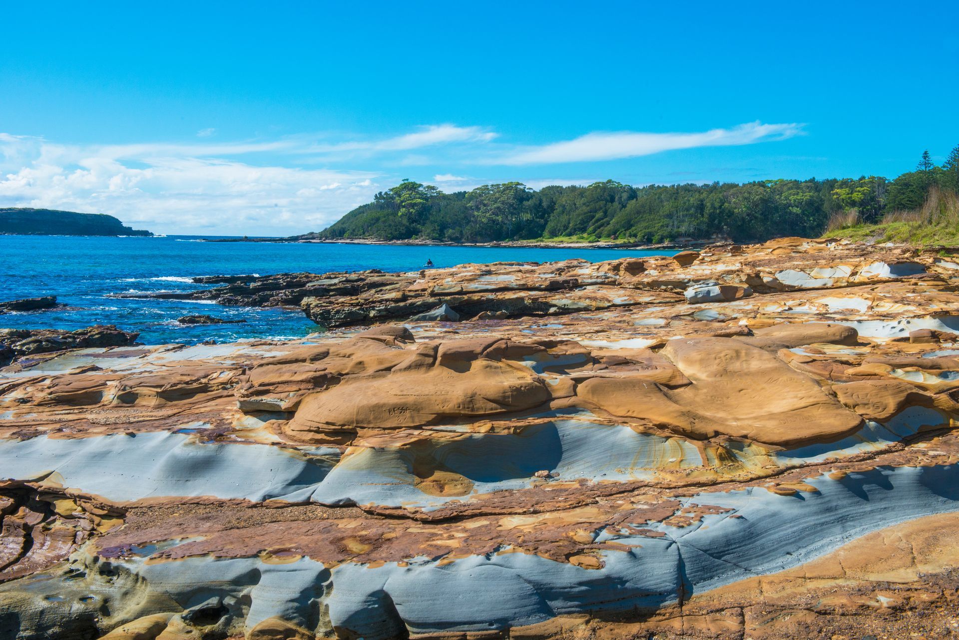 A Rocky Shoreline With a Body of Water — BayCoast Electrical & Control Solutions In South Durras, NSW