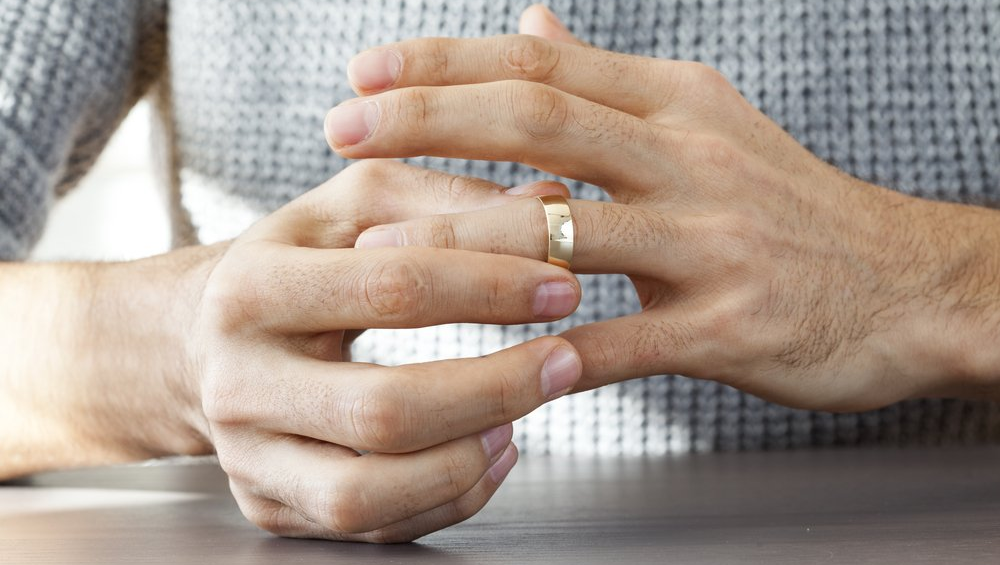 Man taking off his wedding ring