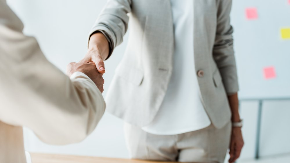 female divorce lawyer shaking a clients hand