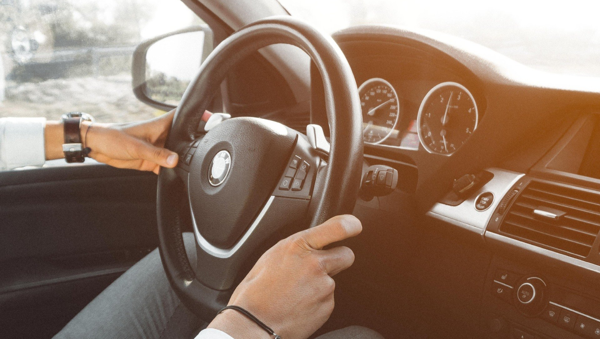 man driving a BMW car