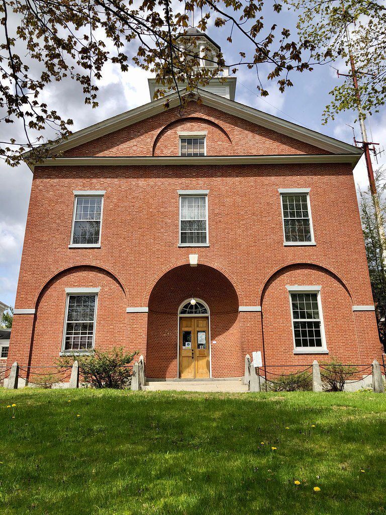 A large brick building with a clock tower on top of it.
