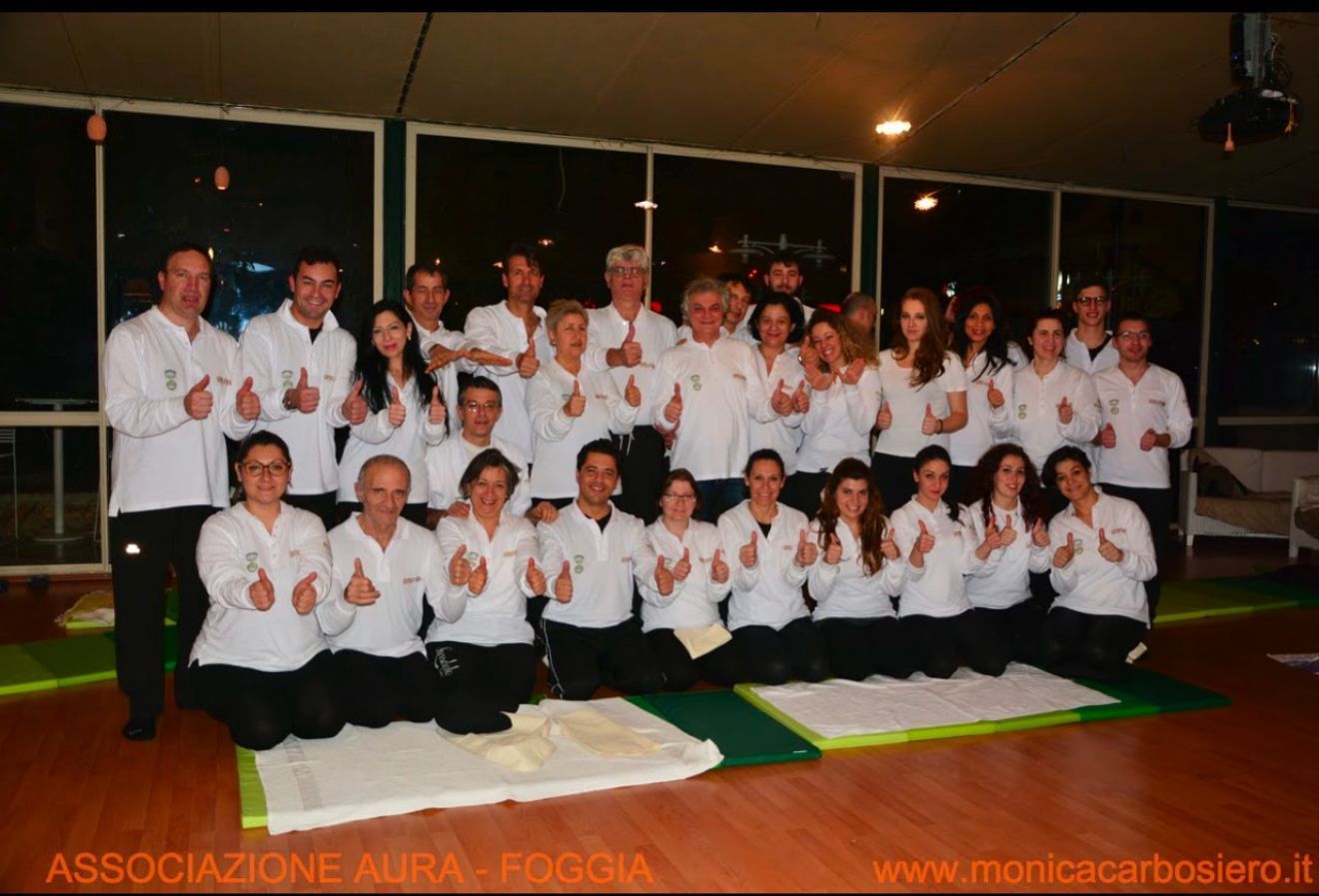 Un folto gruppo di persone che posano per una foto con i pollici in su