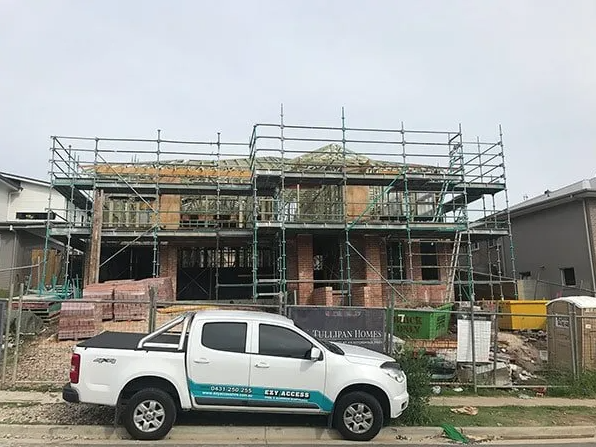 Pickup Truck In Front Of Ongoing House Construction — Scaffolding in Tuggerah, NSW