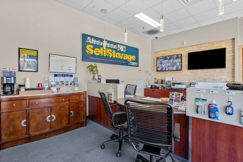Interior view of Aberdeen NC Self Storage office with reception desk and signage.
