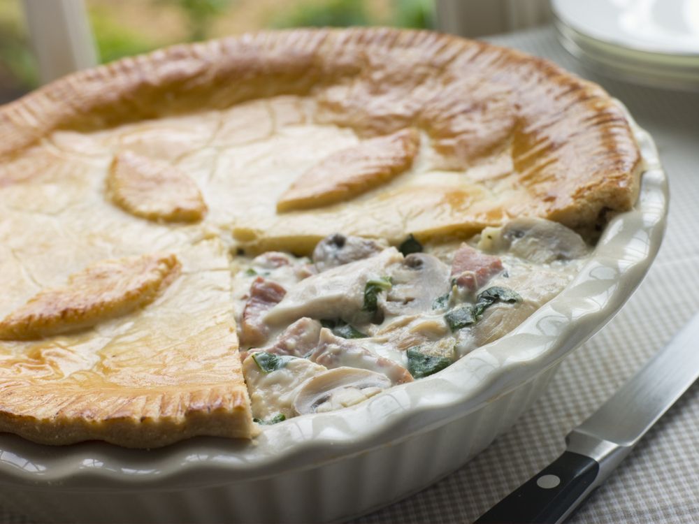 A Pot Pie With A Slice Taken Out Of It Is Sitting On A Table — Edgeworth Meat & More in Edgeworth, NSW