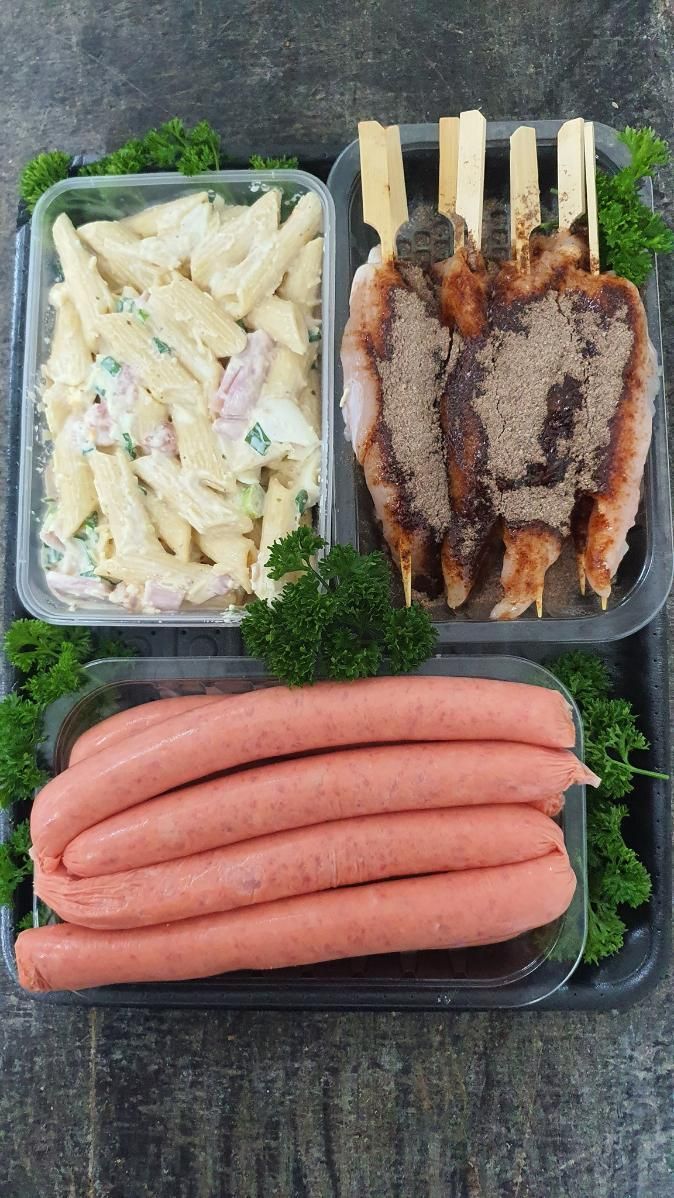 A Black Tray Filled With Raw Meat And Greens — Edgeworth Meat & More in Edgeworth, NSW