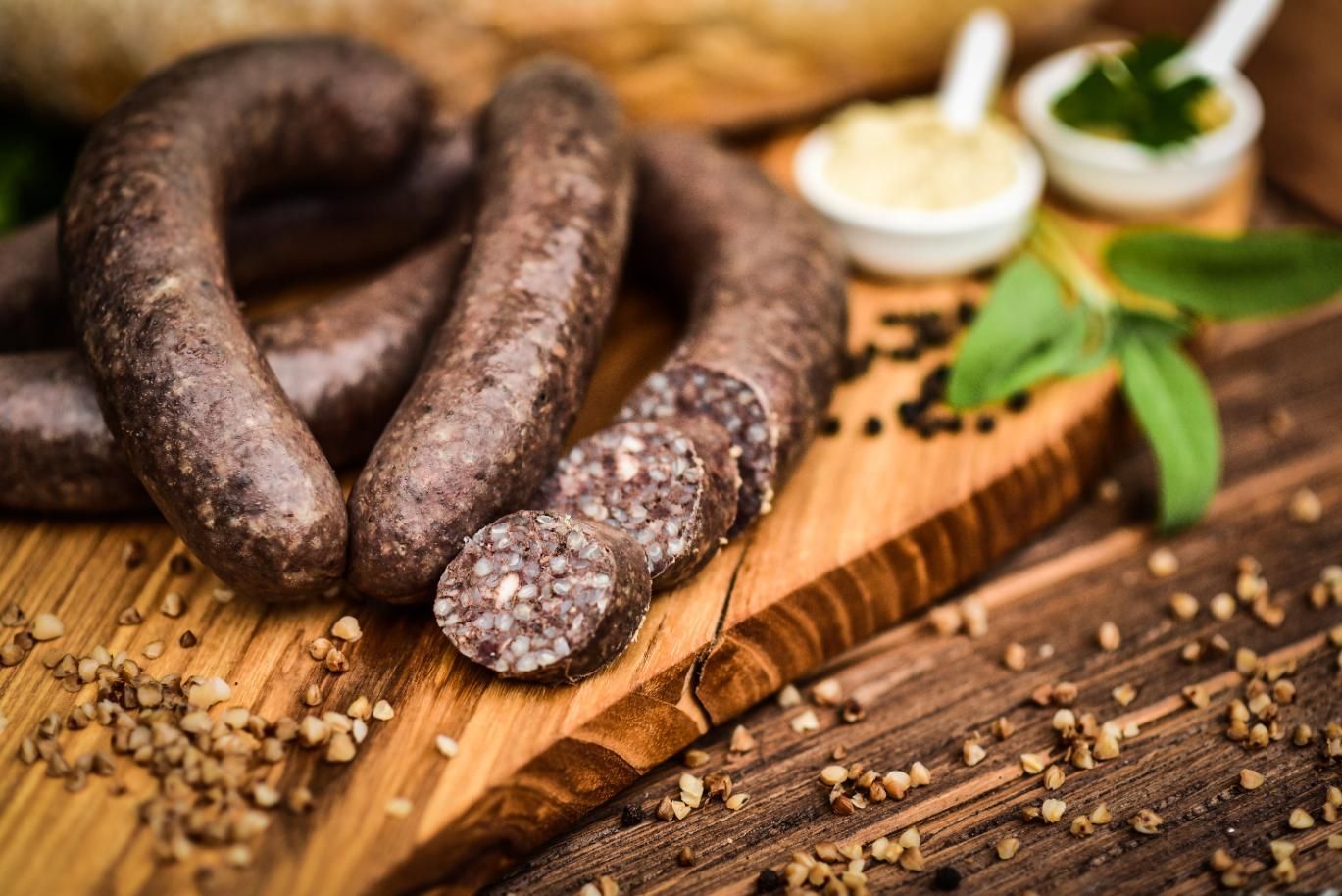 A Bunch Of Sausages Are Sitting On A Wooden Cutting Board — Edgeworth Meat & More in Edgeworth, NSW