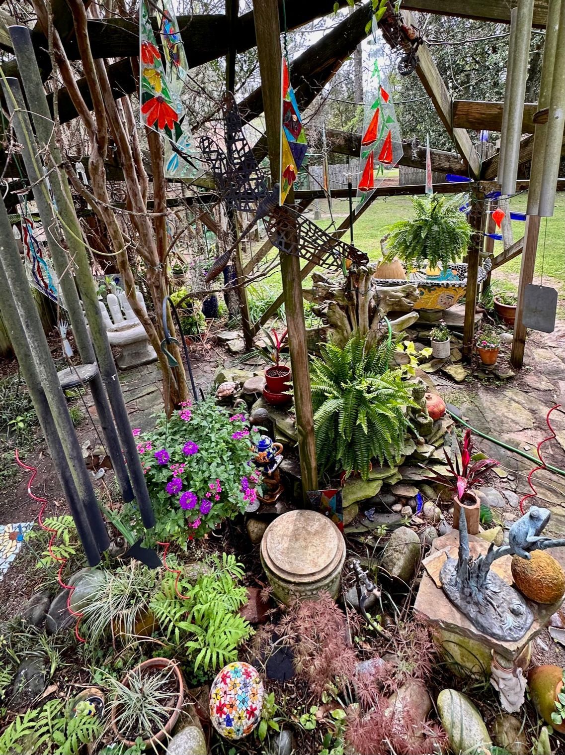 A garden filled with lots of plants , rocks , and flowers.