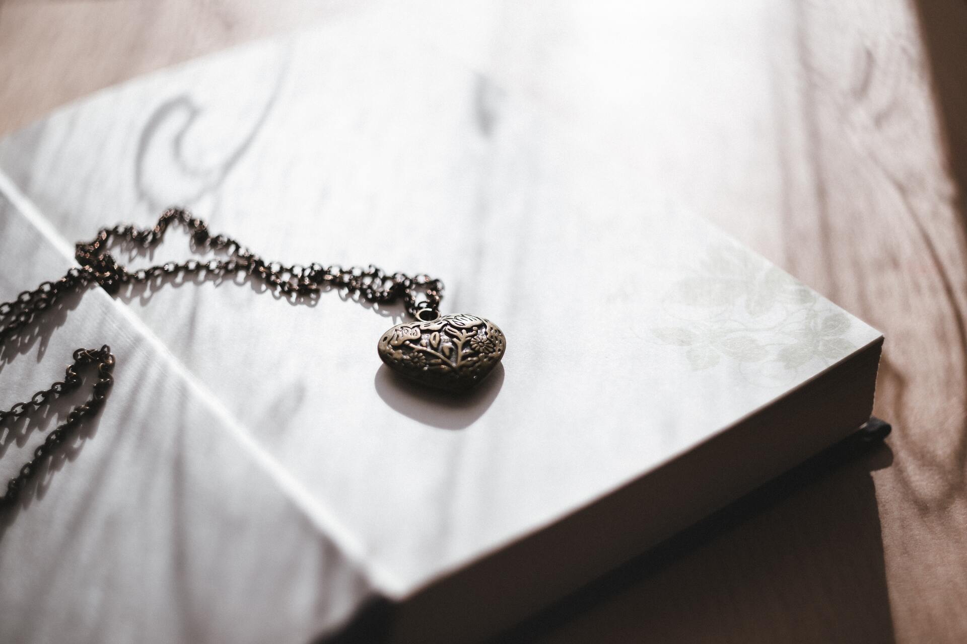 cremation services necklace locket on book
