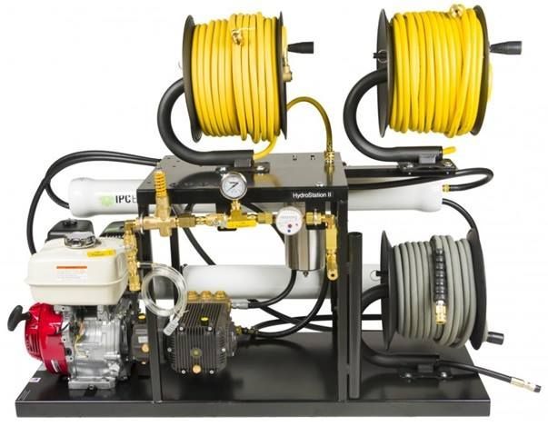 A machine with two spools of yellow hose attached to it