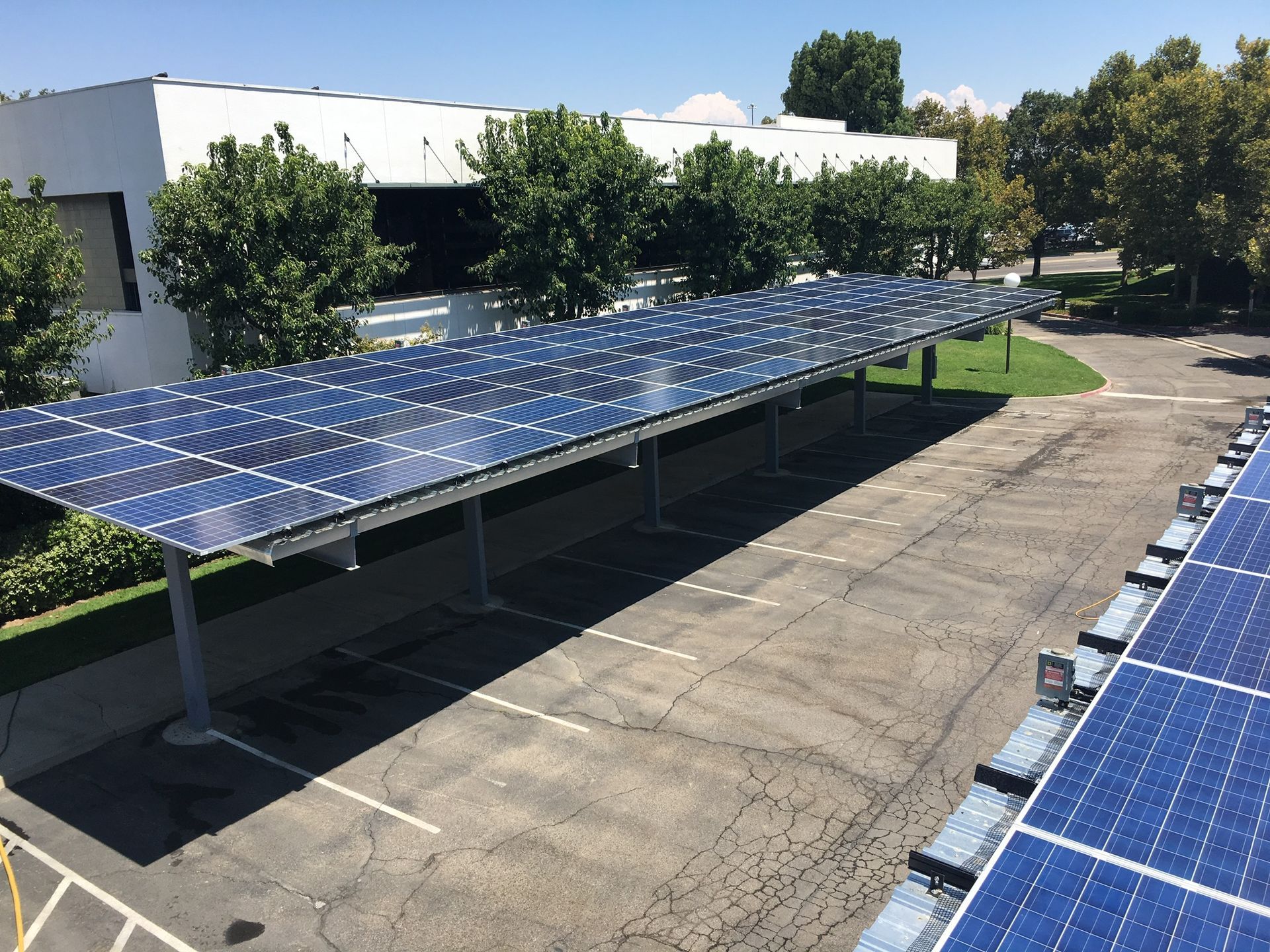 A parking lot with solar panels on the roof
