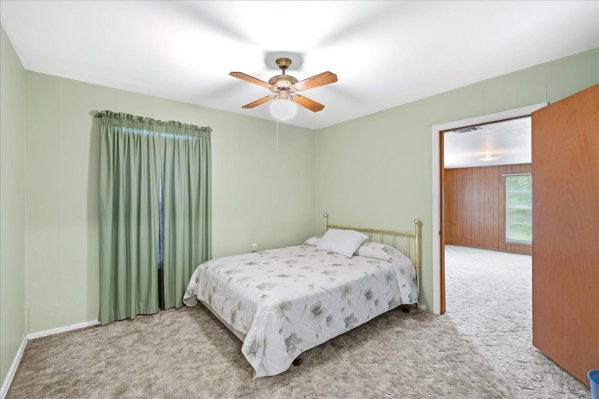 Bedroom with Green Curtain — Rockdale, TX — Carol Matous - Jim Currey Realty