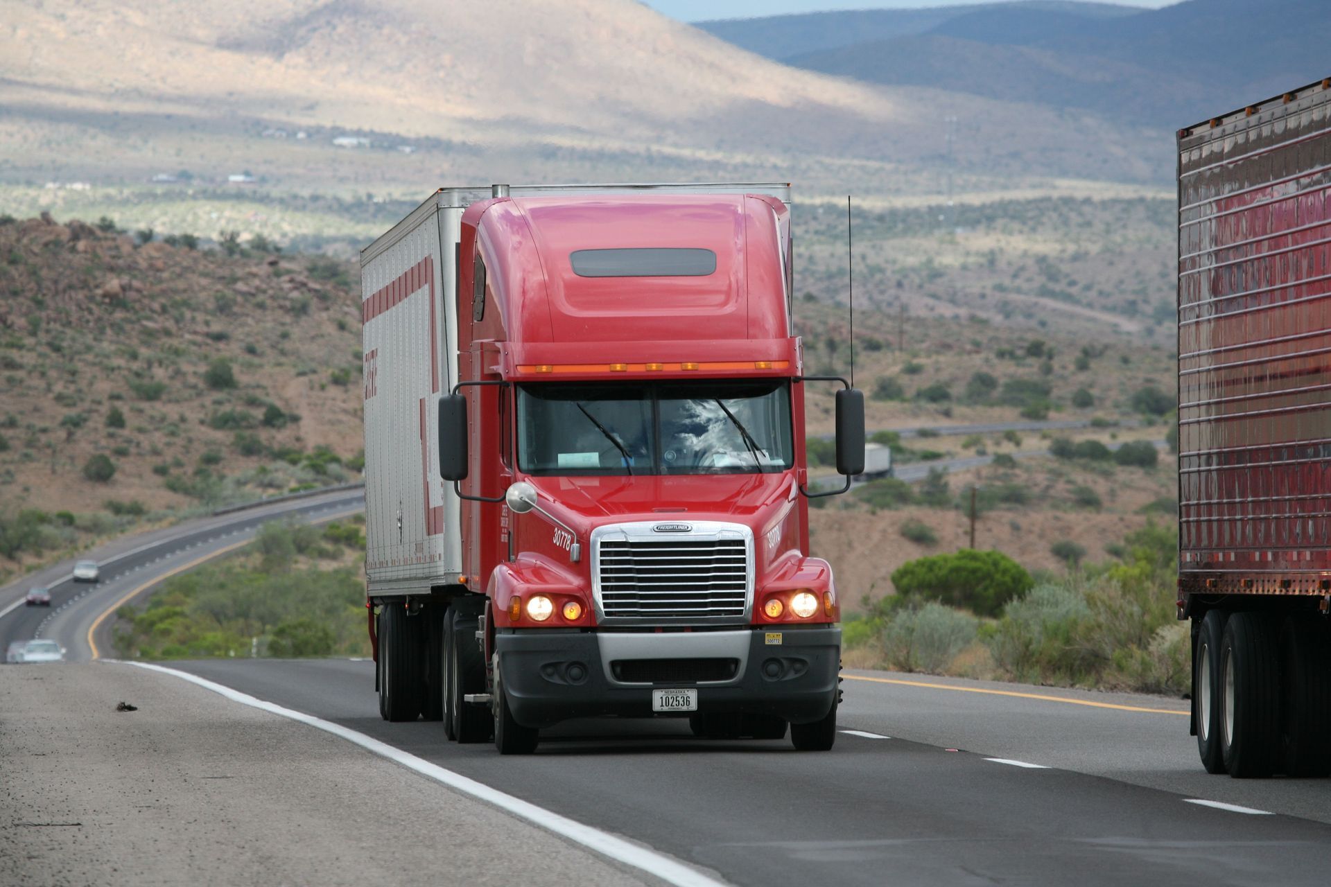 Red semi-truck hauling freight on a Texas highway, illustrating motor truck cargo insurance coverage