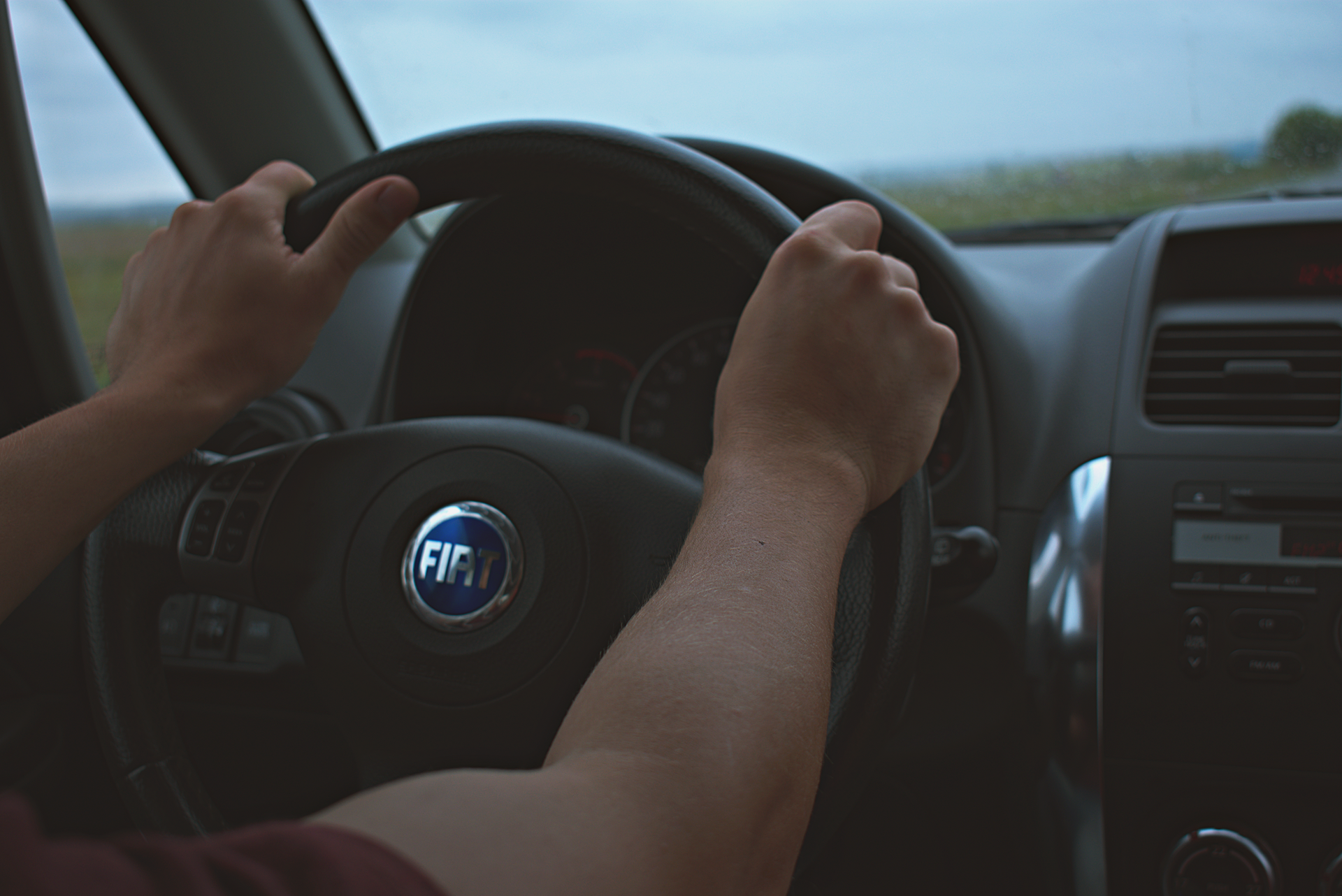 Close-up of a Texas driver's hands on the steering wheel, illustrating SR-22 high-risk auto insuranc