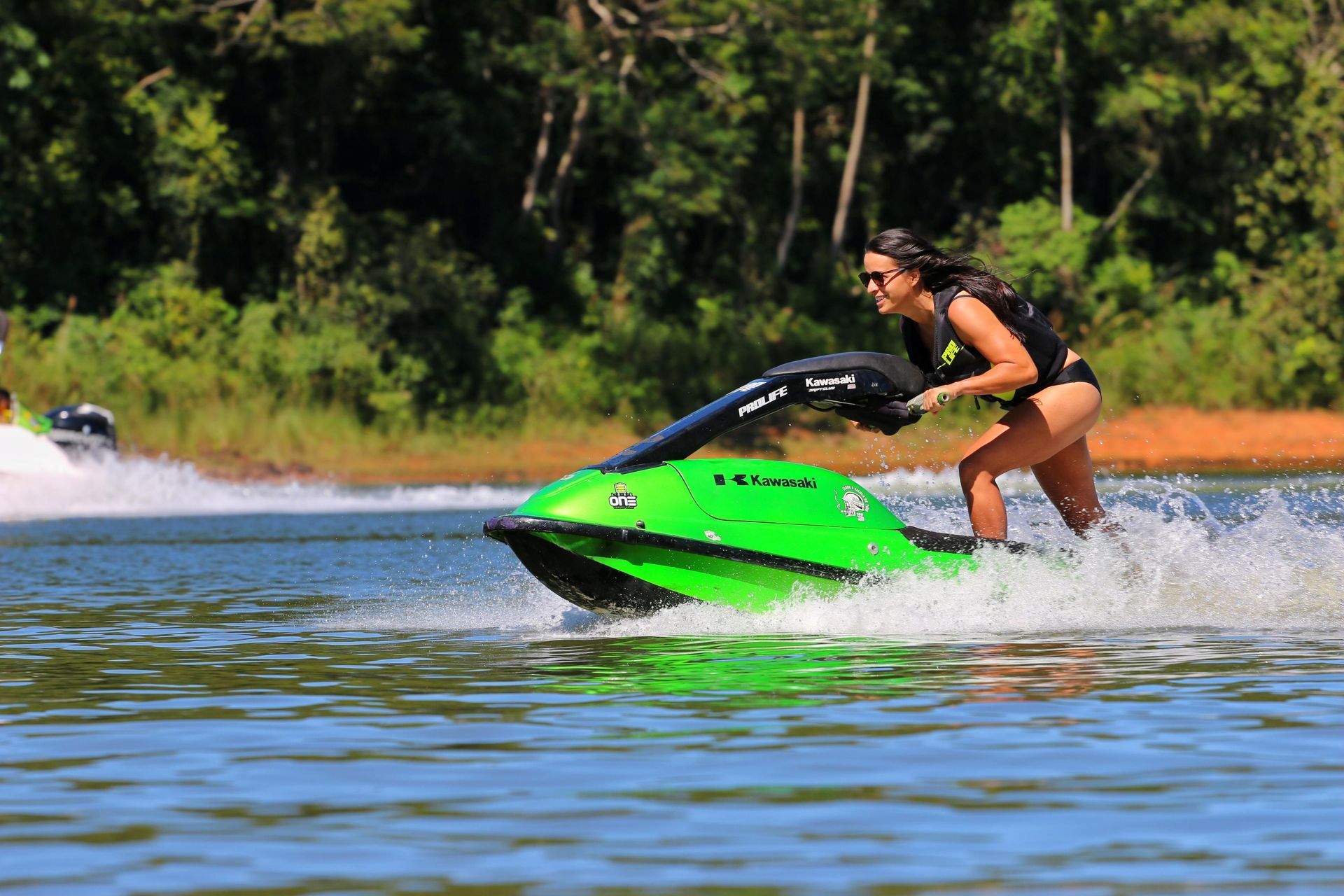 Rider on a personal watercraft crossing a North Texas lake on a summer afternoon