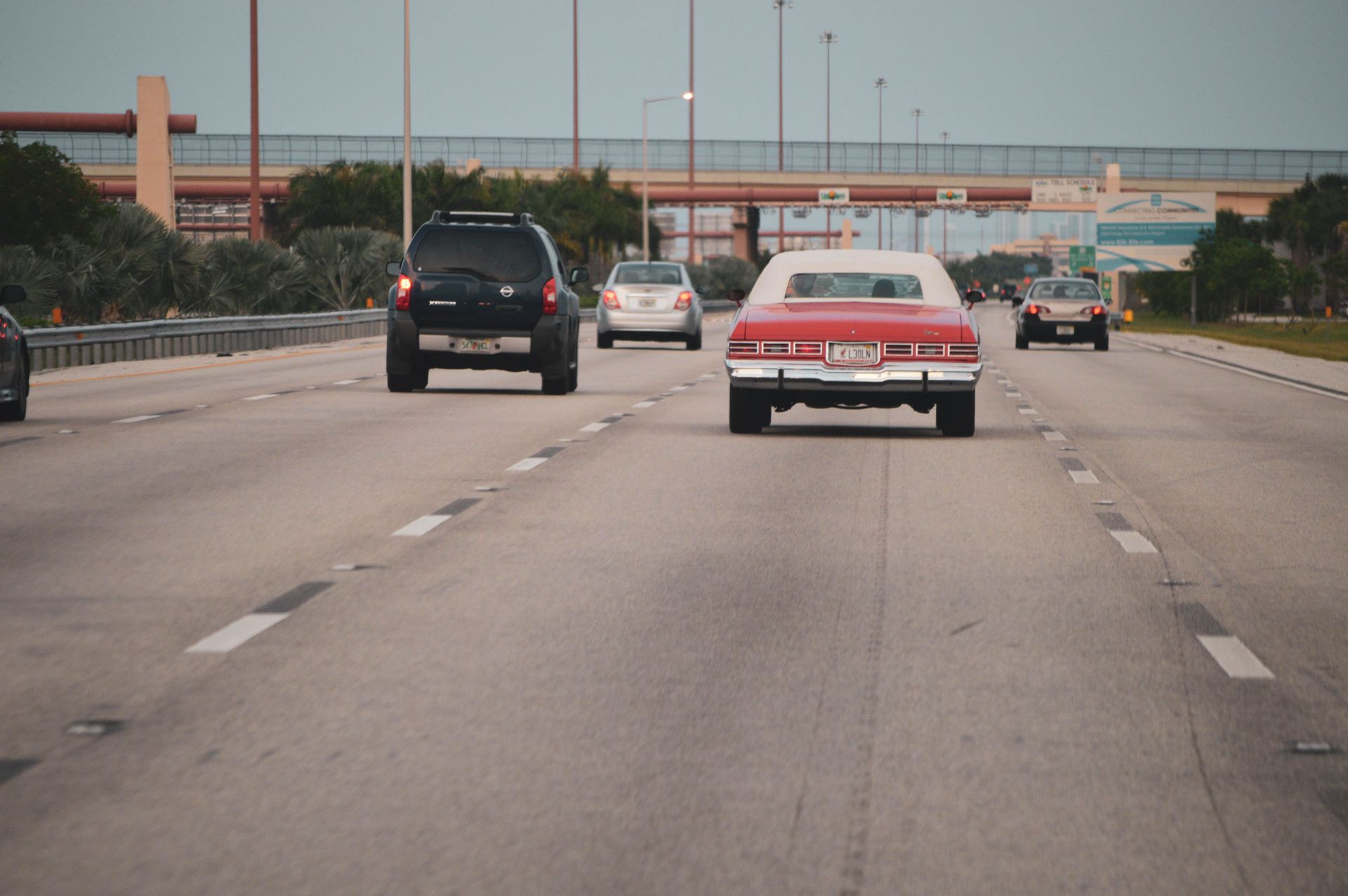 Cars on a busy multi-lane Texas highway, illustrating full coverage versus liability-only auto insur