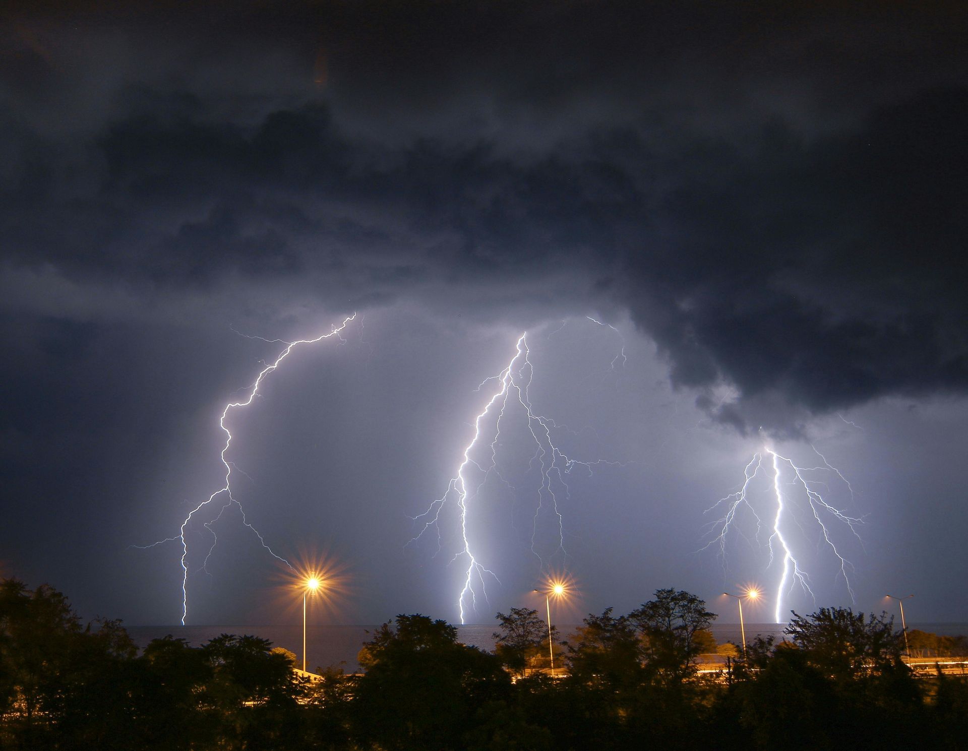 Hail damaged car windshield and roof shingles representing Texas hail season insurance coverage for homes and vehicles in DFW