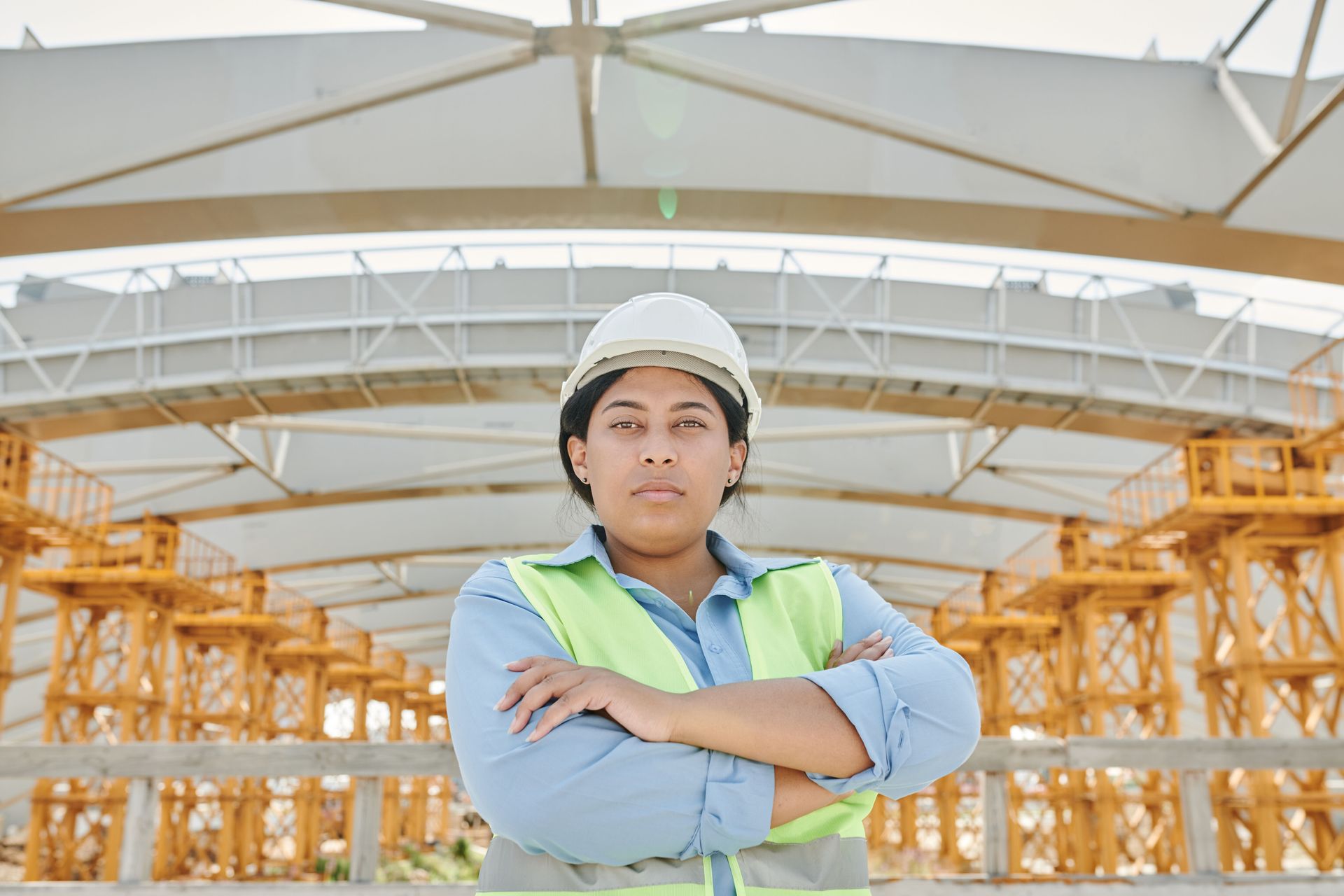 Texas contractor in a hard hat and safety vest at a job site, illustrating additional insured covera