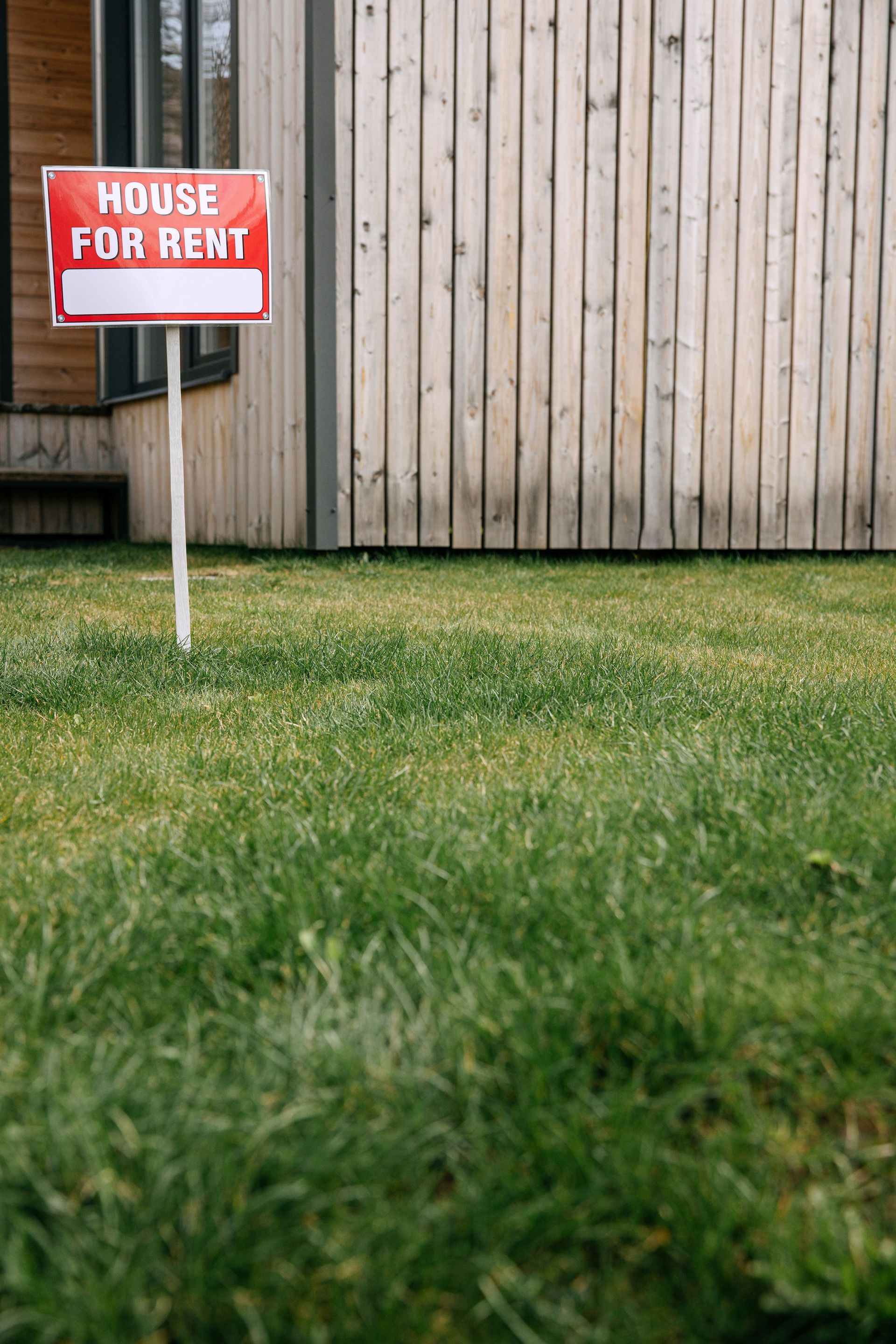 Small rental home in a North Texas neighborhood with a 'For Rent' sign in the front yard.