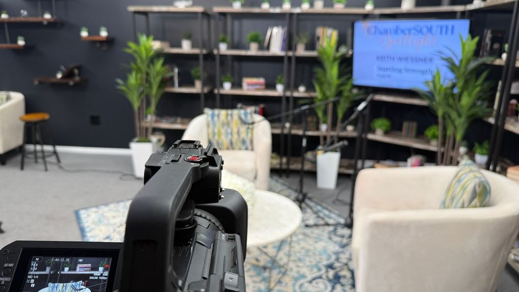 Miami Community Views A camera is taking a picture of a living room with a couch and chairs.