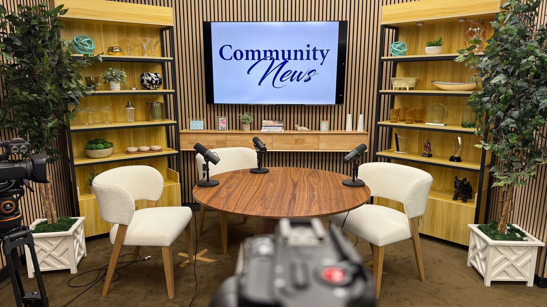 Miami Community Views A room with a table and chairs and a television that says community news.