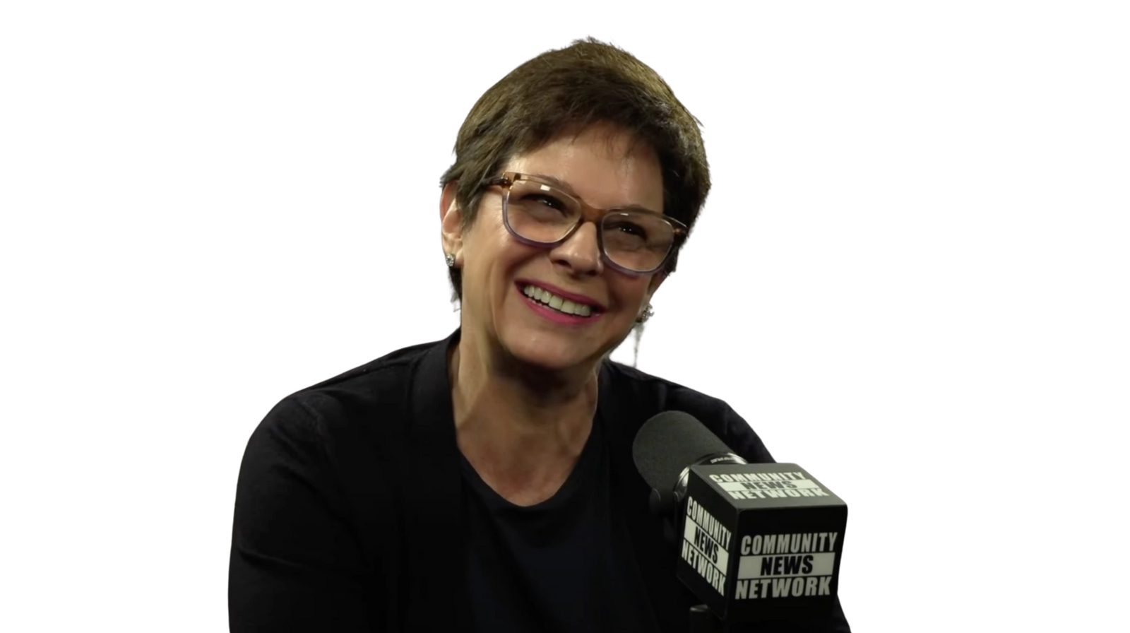 CNEWS TV Woman with glasses and short brown hair smiles while speaking into a microphone.