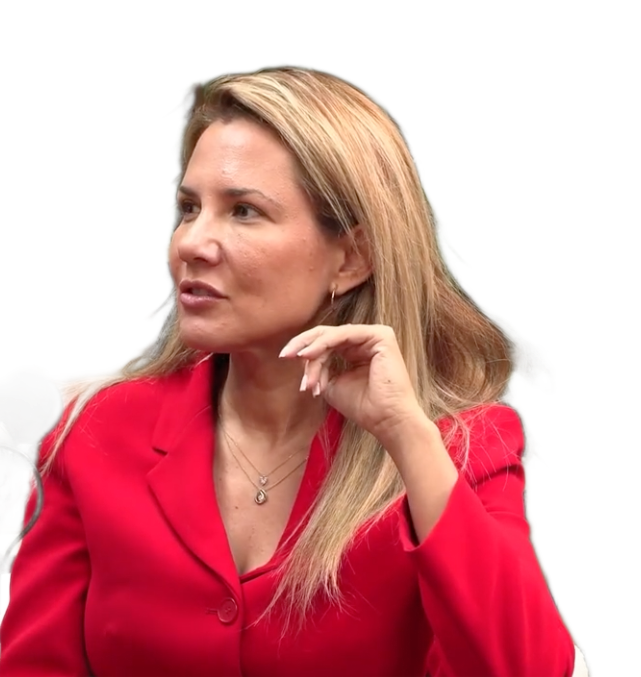 Woman in a red blazer, looking to the side, with long blonde hair, and a necklace.