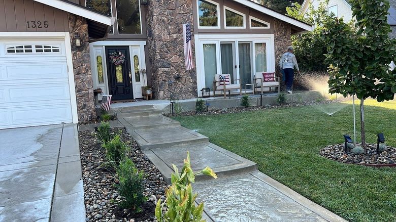Concrete front pathway and landscaping at Stockton residence.