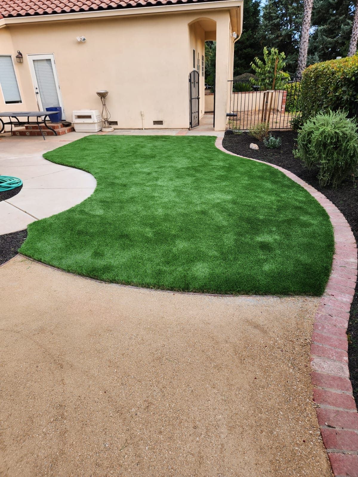 Artificial turf laid on a backyard patio for a clean and affordable outdoor space in Stockton