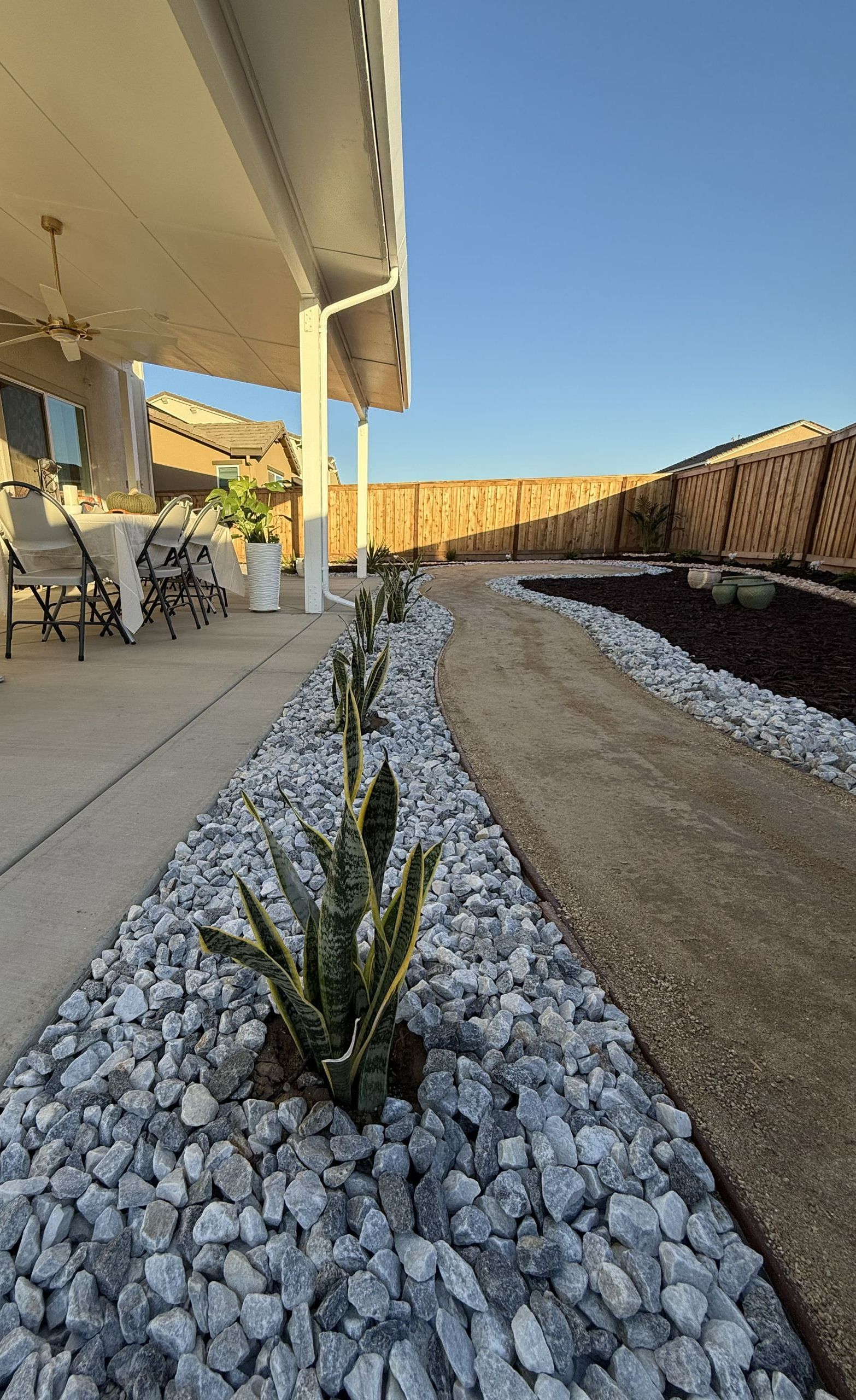 Landscape design with rock, plants, and dirt for planting in Stockton.