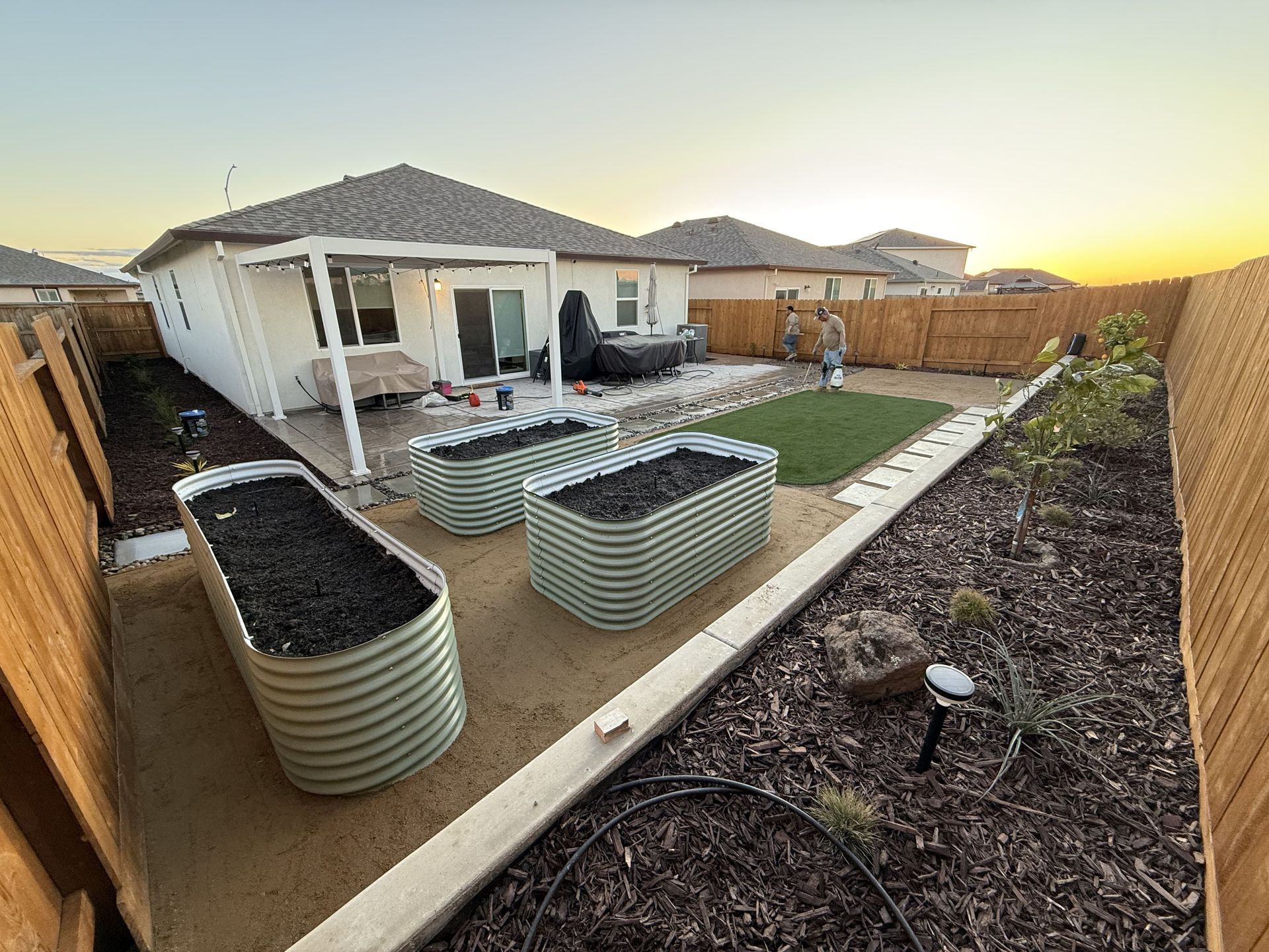Full view of backyard landscape design with dirt planters in Stockton CA.
