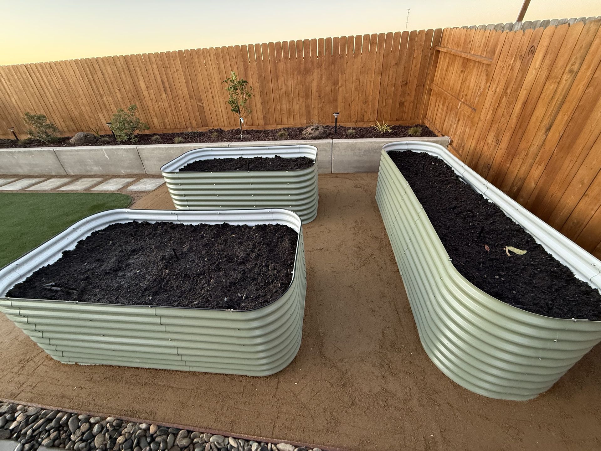 Landscape design with dirt planters prepared for planting in Stockton.