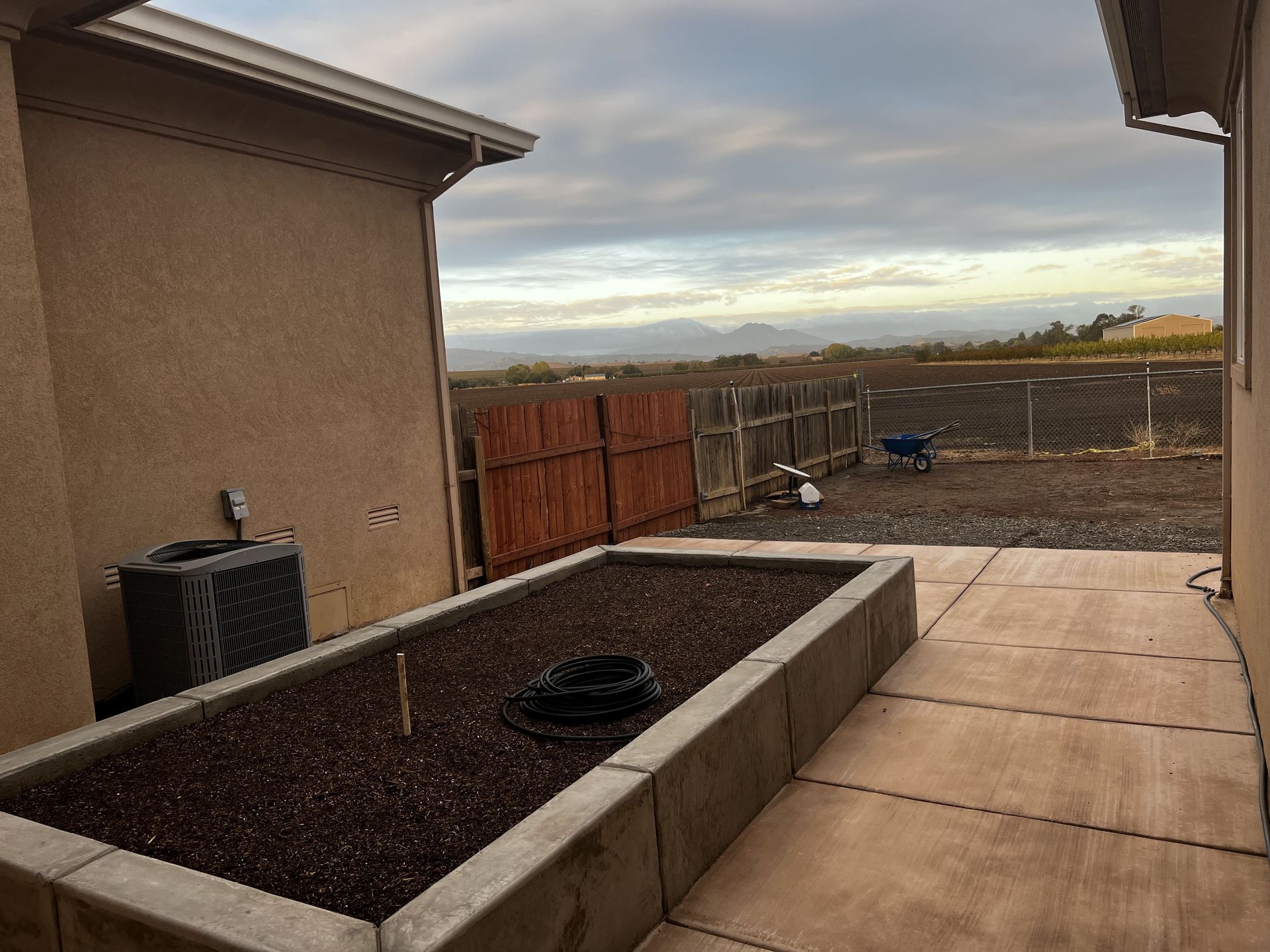Custom concrete planter integrated into Stockton patio landscape.