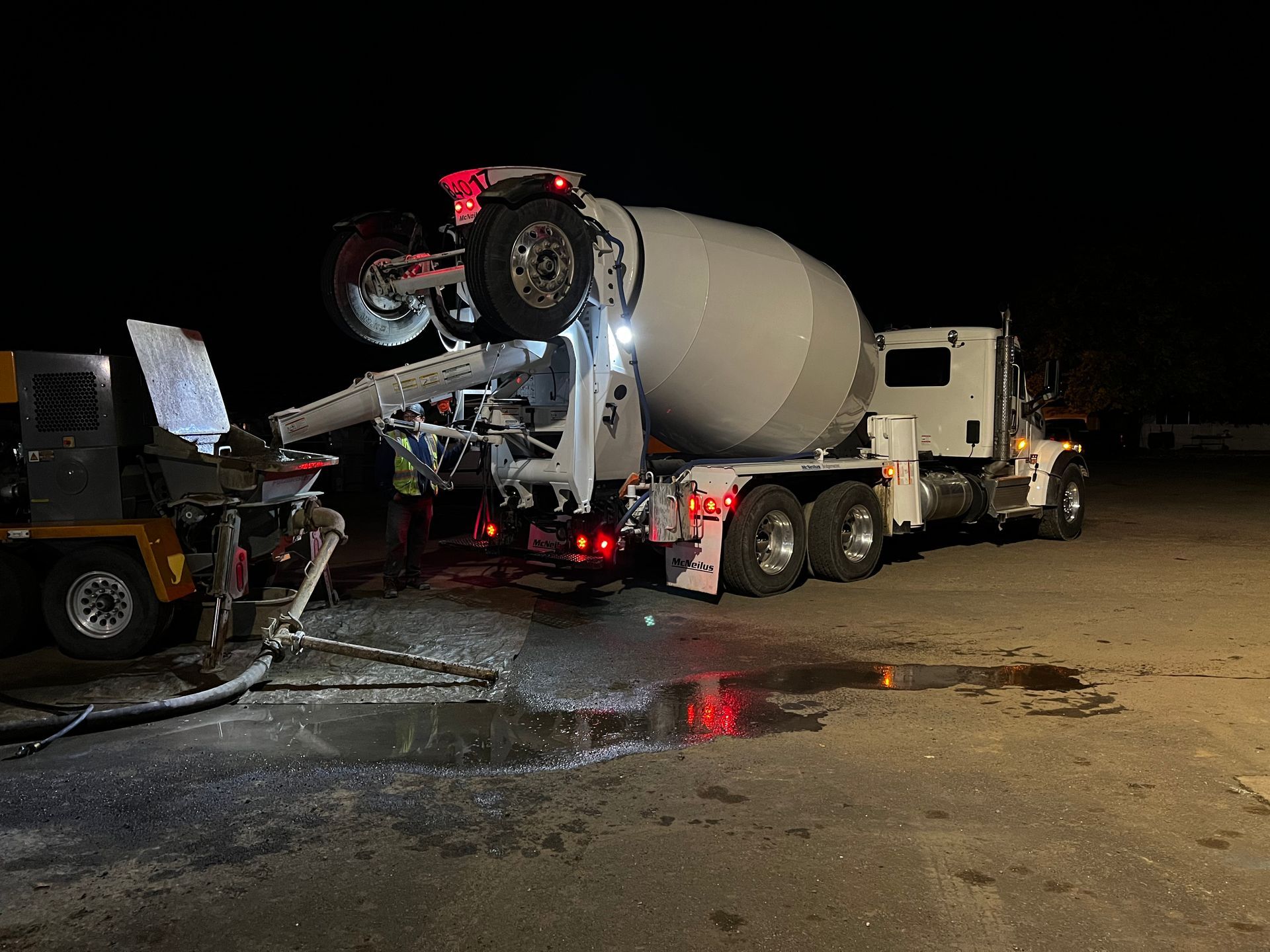 Concrete mixer truck pouring fresh concrete for a new driveway installation in Stockton, CA