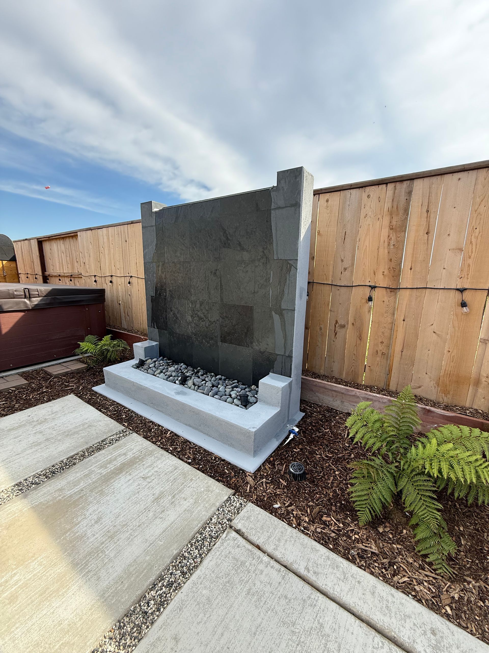 Backyard hardscaping project with pavers and retaining wall in Stockton that boosted home value 