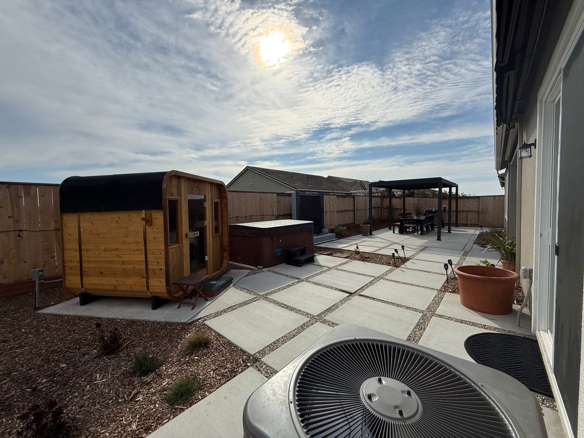Full view of backyard with concrete and decorative rock in Stockton.
