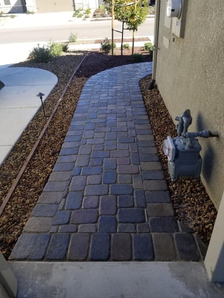 Paver walkway installation in a Stockton backyard with modern stone design and clean edging.