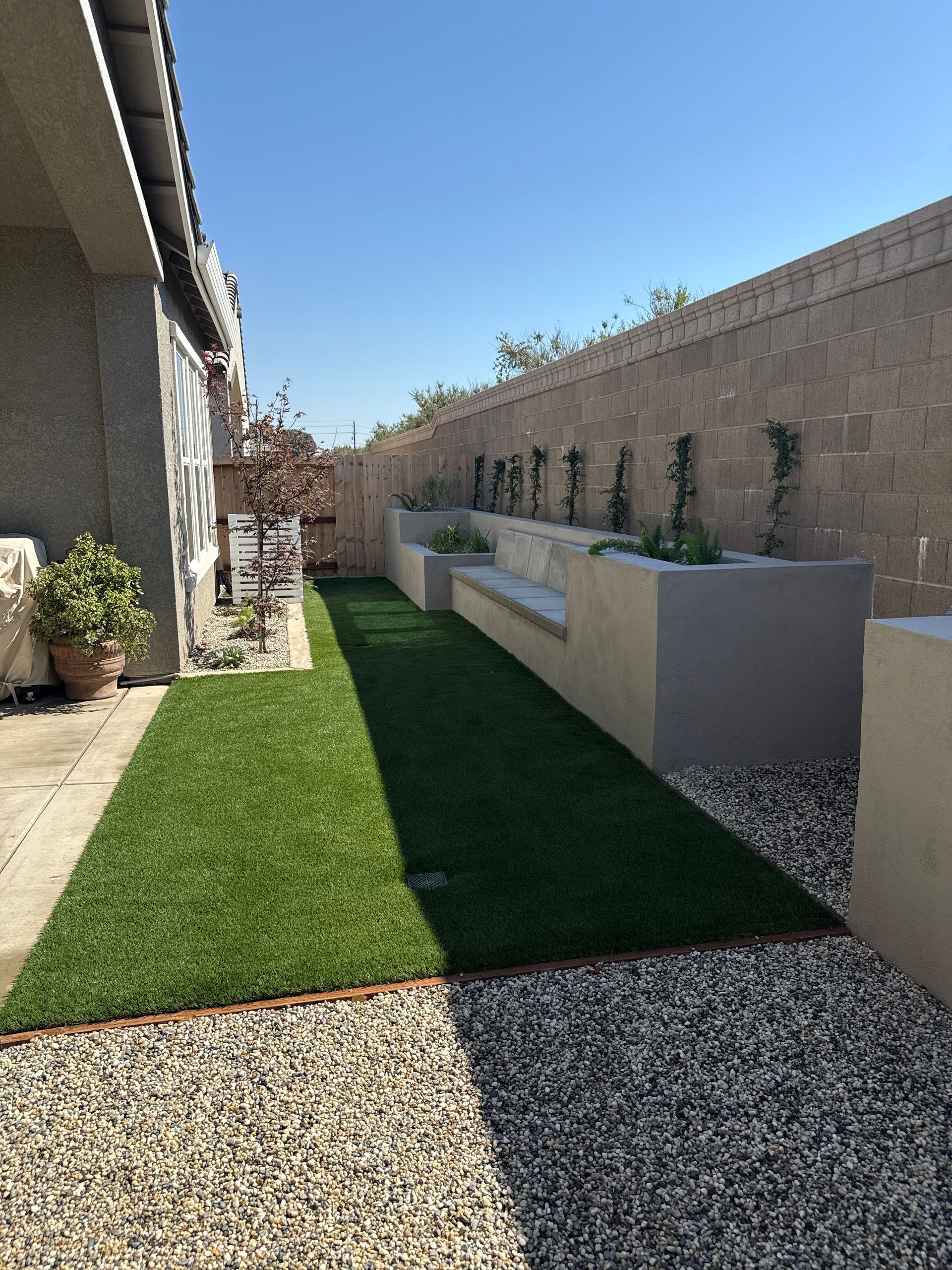 Concrete seating area in a professionally designed Stockton backyard with integrated patio space