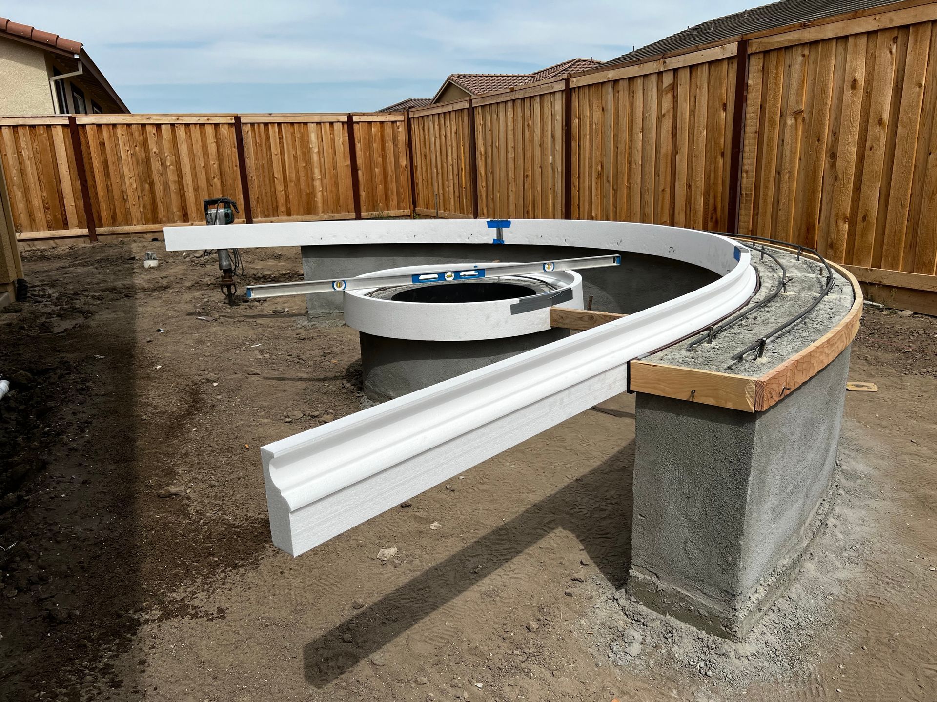 Concrete border installation during landscaping build in Stockton.
