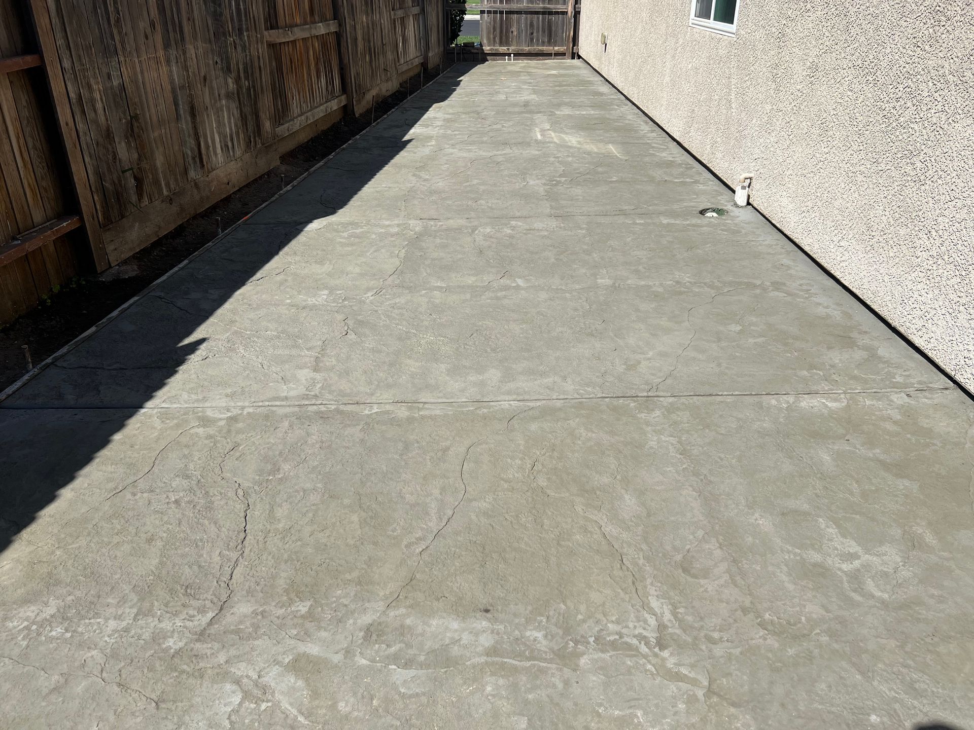 Close-up of newly installed concrete walkway showing smooth finish and clean edges